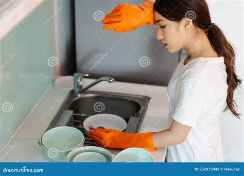 The Asian Woman Is Washing Dishes In A Tired Mood Stock Image Image