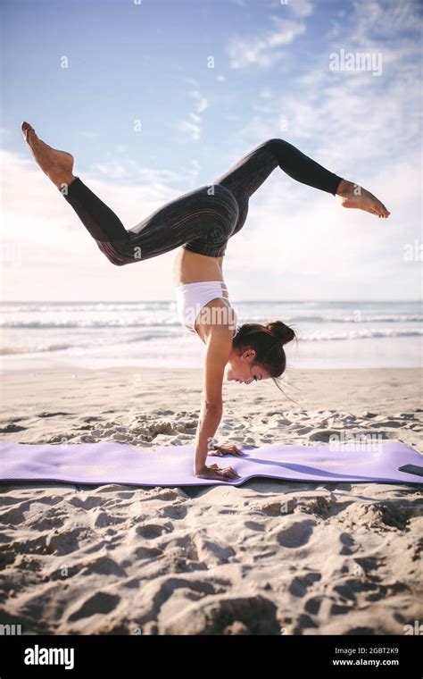 Young Woman Doing Handstand On Beach Hi Res Stock Photography And