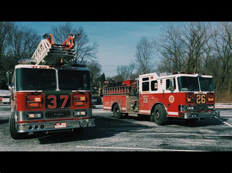two fire trucks parked next to each other in a parking lot