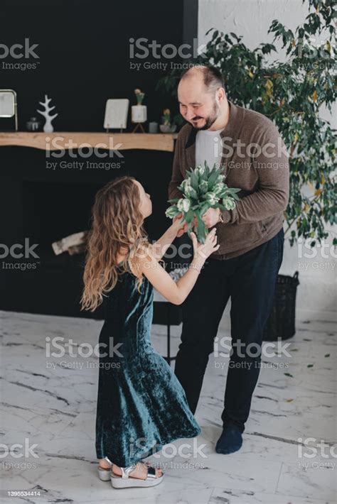 A Father Gives Flowers To His Daughter Stock Photo Download Image Now