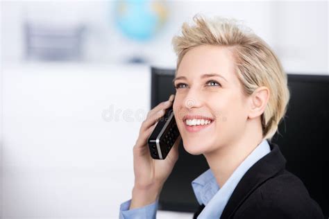 woman using cordless phone while looking up in office stock image image of caucasian