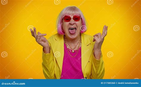 senior old grandma woman making playful silly face expressions grimacing fooling showing
