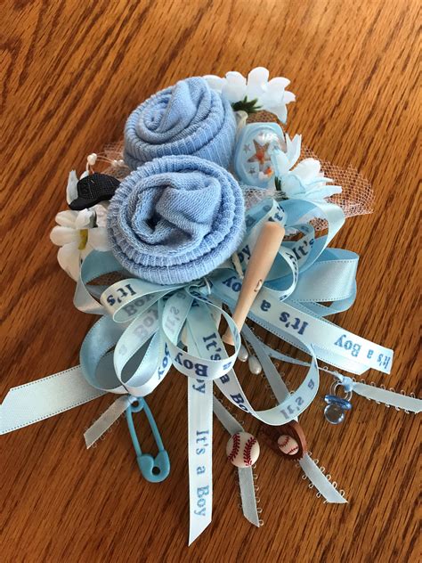 Each corsage is made using a pair of infant socks, flowers, miniature baby rattle, net, pearls, pink or blue dipper pins or miniature pacifier and ribbon. Baseball Theme Baby Sock Baby Shower Corsages-Handmade ...