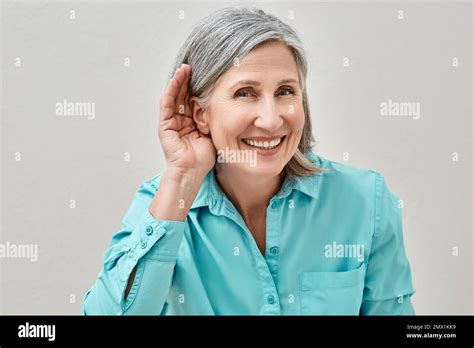 Mature Woman Listening Sound With Hand Near Ear For Hearing Check Up