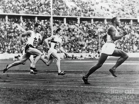Jesse Owens Running The 200 Meter Race By Bettmann
