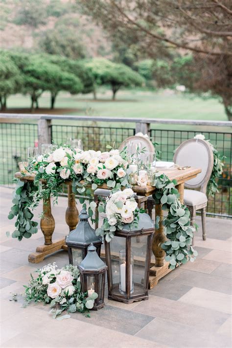 Sweetheart Table With Garland And Lanterns Rustic Wedding At The Ranch