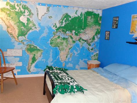 A Bed Room With A Large Map On The Wall