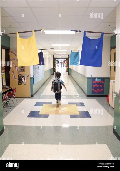 Little Boy Walking Down Hallway At School Stock Photo Alamy