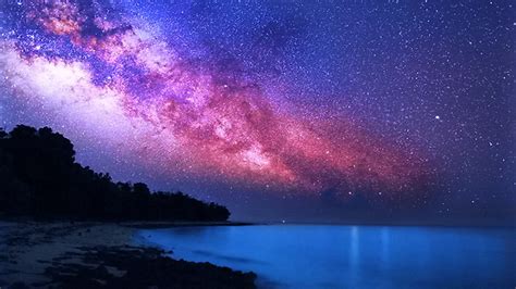Calm Body Of Water And Green Trees Sand Under Milky Way Starry Clouds