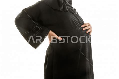 Portrait Of A Pregnant Saudi Arabian Gulf Woman Wearing A Maternity Abaya Different Hands And