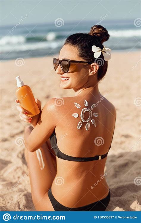Beauty Woman Applying Sun Cream On Tanned Shoulder In Form Of The Sun Sun Protection Stock