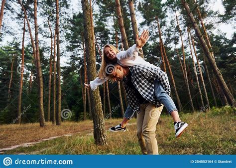 Woman Is Riding Her Man Happy Couple Is Outdoors In The Forest At
