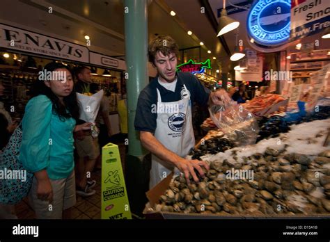 Fishmongers Sell Seafood At The Pike Place Market In Downtown Seattle