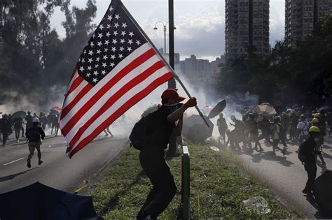 The hong kong flag shows a flower, the bauhinia blakeana, on a red field. American flags in Hong Kong show people still fight for ...