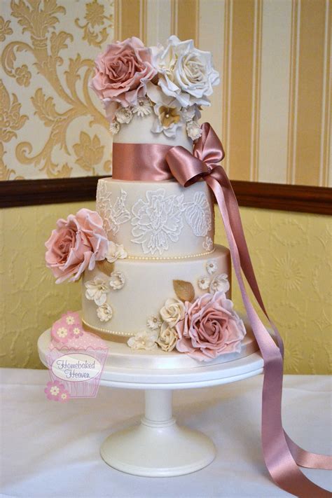 wedding cake with dusky pink and ivory roses daisies fantasy flowers and royal icing lace