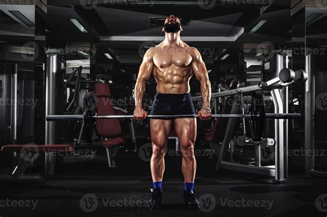 Muscular Man Lifting Some Heavy Barbells 712933 Stock Photo At Vecteezy