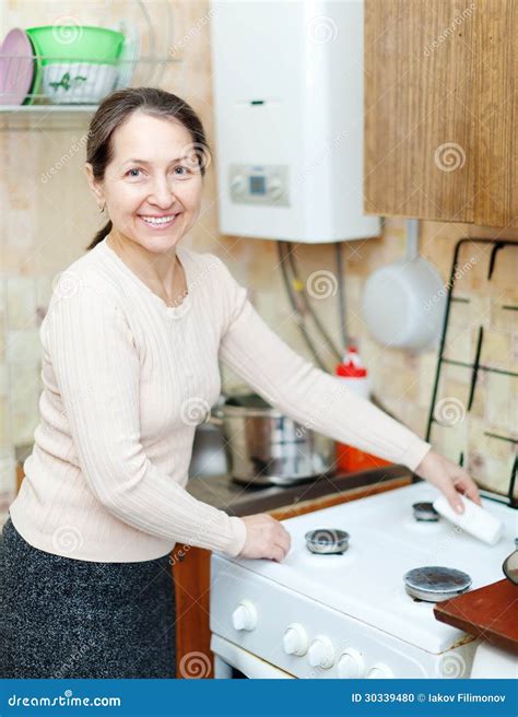 Mature Housewife Cleans The Gas Stove Stock Photo Image 30339480