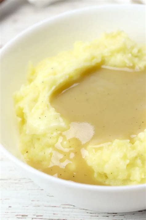 a bowl filled with mashed potatoes and gravy
