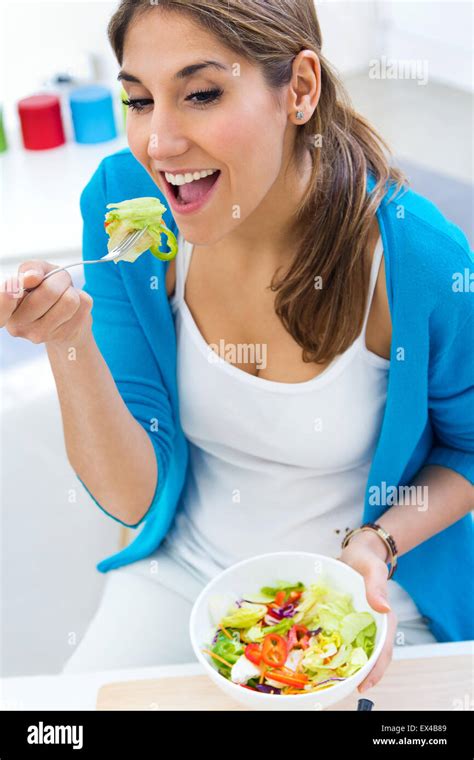 Portrait Of Pretty Young Woman Eating Salad At Home Stock Photo Alamy