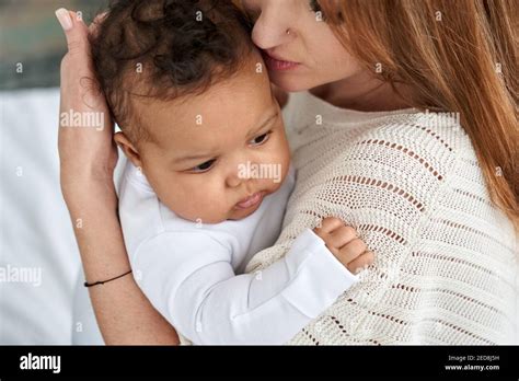 Loving Caucasian Mother Hugging Cute Infant African American Baby Babe Stock Photo Alamy