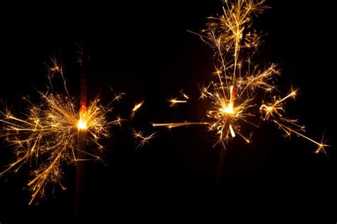 Free Photo Dark Background With Two Lit Sparklers
