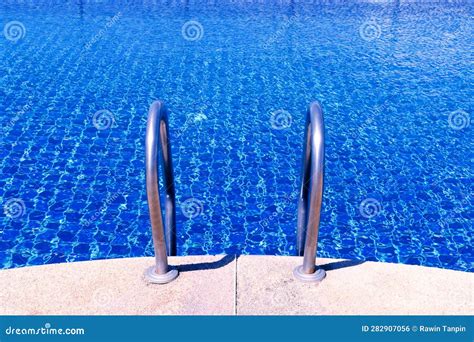 Swimming Pool With Stair At Hotel Close Up Ladder Stainless Handrails