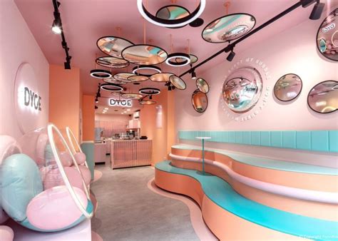 A Pink And Blue Room With Circular Mirrors Hanging From The Ceiling