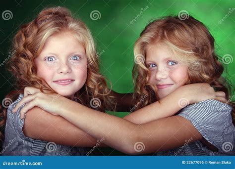 Portrait Of Twin Girls Holding Each Other Stock Photo Image Of