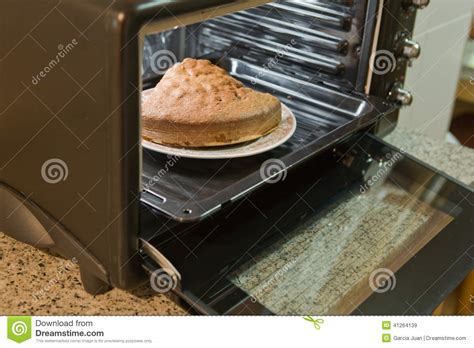 How to bake a cake using a sufuria in an oven. Sponge cake in the oven stock image. Image of cooking - 41264139