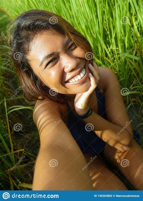 Young Happy And Exotic Islander Asian Girl From Indonesia Taking Selfie