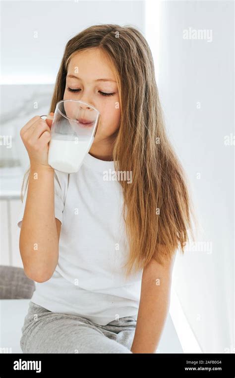 Smiling Little Girl Drinking Milk Stock Photo Alamy