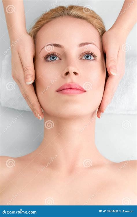 Young Woman In Spa Gets A Facial Massage Stock Photo Image Of