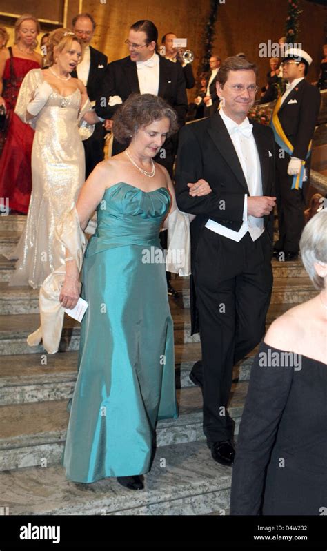german foreign minister guido westerwelle leads vera rosenberry ramakrishnan to the banquet