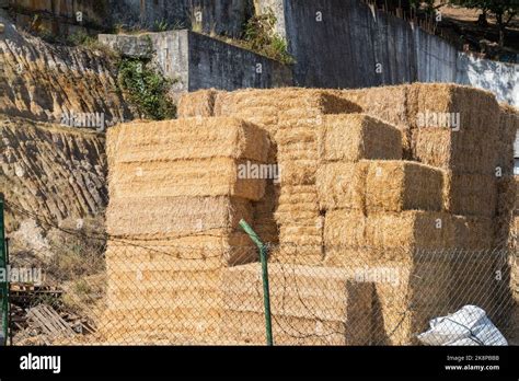 An Aerial View Of Various Hay Straw Bales Stored Behind Wire Fences