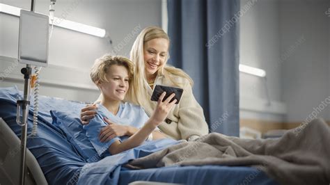mother visiting son in hospital stock image f032 8919 science photo library