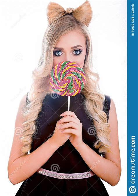Blonde Attractive Woman Close Up With Very Big Blue Eyes And A Ribbon