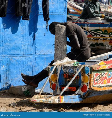 Unidentified Senegalese Man Sits On The Boat On The Coast Of Th