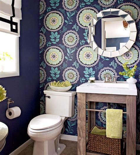 In this half bath, one wall of patterned wallpaper is all it takes to