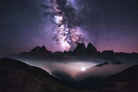 Milky Way Over Mountains In Fog At Night In Summer Landscape With