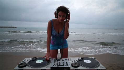 A Beautiful Sexy Female Dj Plays At The Beach At Sunrise Great Clip For Clubs Fashion And