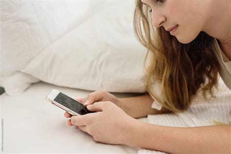 Teen Girl Texting In Her Bedroom By Stocksy Contributor Gillian Vann