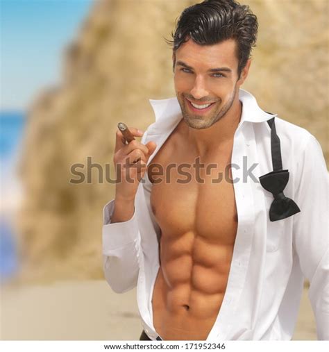 Sexy Muscular Handsome Man With Big Smile And Open Shirt Holding Cigar