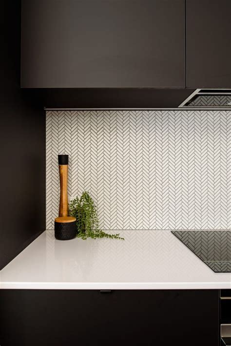 White Mosaic Herringbone Tiles With Black Grout White Kitchen