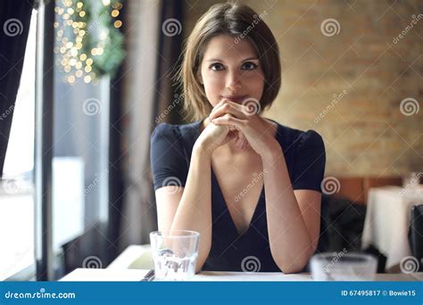 Young Woman Sitting At A Restaurant Table Stock Image Image Of