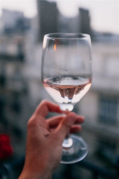 As a general rule, hold the glass by its stem instead of holding it around the try to hold the glass only when taking sips. Close-Up Photo of Person Holding Wine Glass · Free Stock Photo
