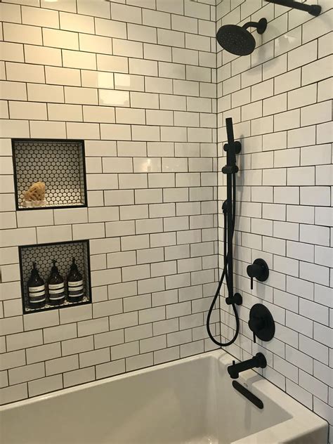 The pointed details of the shower — beginning with the matte black shower faucet, sleek lever handles, and textured glass shower screen — all contribute to the modern design of the room, while the terra cotta walls offer an. Small hex tile in nook. Subway w grey grout. Kohler ...