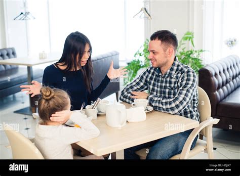 Couple Fighting In Front Of Child At Cafe Or Restaurant Stock Photo Alamy