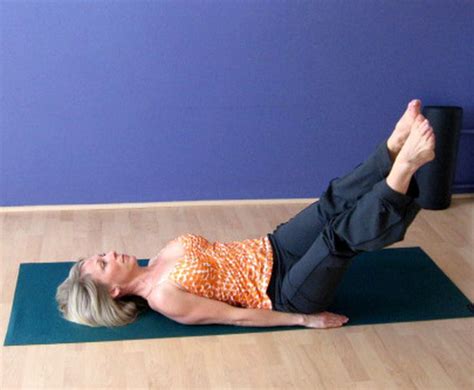 A Woman Is Laying On Her Stomach While Doing Yoga