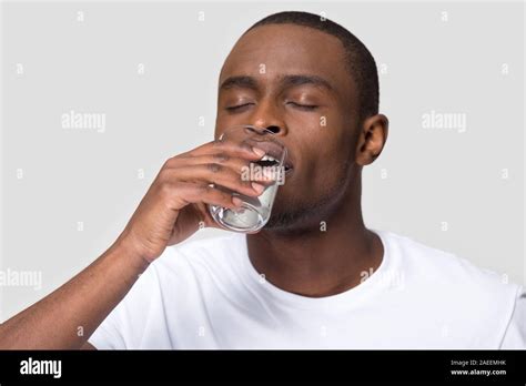 Healthy Thirsty African American Man Drinking Clean Mineral Water Stock