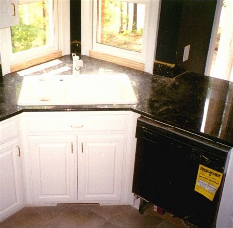 Kitchen sinks are usually fastened to the countertop by a combination of caulk, glue and clips on the underside. corner sink I like the idea of having a corner cabinet ...